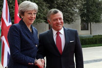 Britain's Prime Minister Theresa May with Jordan's King Abdullah II as he receives her at the royal palace in Amman. Khalil Mazraawi/ AFP Photo