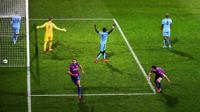 Glenn Murray, third from left, celebrates scoring the opening goal as Crystal Palace go on to hand Manchester City a dent to their hopes of chasing down Chelsea for the Premier League title. Jamie McDonald / Getty Images