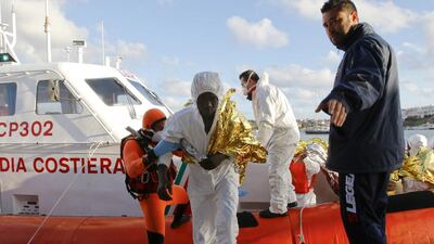 A migrant who survived a shipwreck is helped as he arrives at the Lampedusa harbour on February 11, 2015. Antonio Parrinello / Reuters
