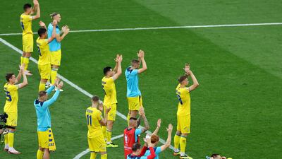 Ukraine players applaud their fans after the match. Reuters