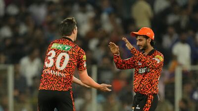 Sunrisers Hyderabad's captain Pat Cummins, left, celebrates the dismissal of Kolkata Knight Riders' Sunil Narine. AP