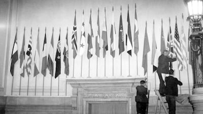 The flags of UN members being put up over the main entrance hall in Central Hall in 1946. Getty Images