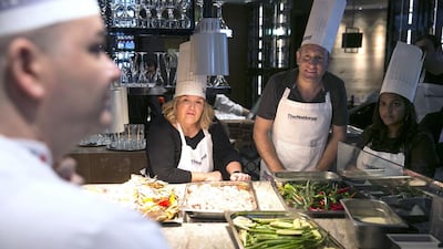 Guests Yogi Karu, Seth Schrenzel, and Haifa al Obaidly look on as Pascal Sfara explains the cooking techniques. Silvia Razgova / The National