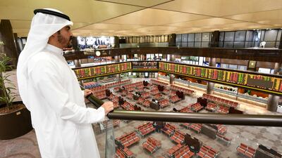 People observe the development of the Boursa Kuwait national stock market, in Kuwait City, Kuwait. EPA