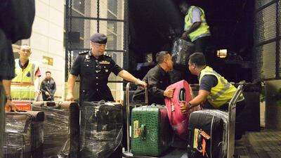 Police load confiscated valuables onto a truck in Kuala Lumpur on May 18, 2018 after raids on homes linked to former prime minister Najib Razak as part of a corruption and money-laundering investigation. AP Photo