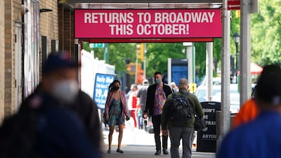 People walk past Broadway show marquees amid the pandemic in New York City on May 13, 2021. Reuters