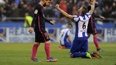 Barcelona’s Lionel Messi, left, walks past Deportivo’s Raul Albentosa after losing 2-1. Paulo Duarte / AP Photo