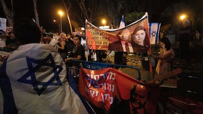 Israeli right-wing activists hold signs showing Naftali Bennett and Ayelet Shaked of the Yamina party, during a demonstration against the possibility of forming a new government in Tel Aviv, Israel. AP Photo