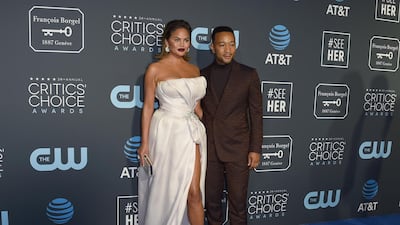 Chrissy Teigen in Maison Yeya and John Legend Ermenegildo Zegna Couture. AP
