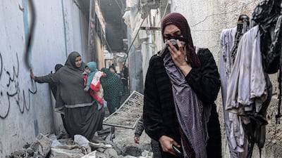 Palestinians negotiate a rubble-strewn alley in Rafah, southern Gaza, following Israeli strikes. A ground offensive is now looming. AFP