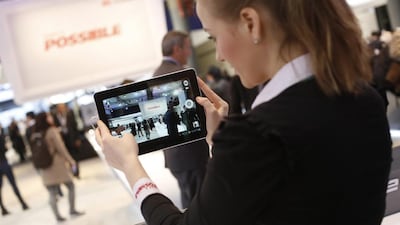 An employee demonstrates a Huawei MediaPad tablet at the Huawei Technologies pavilion during Mobile World Congress in Barcelona. Simon Dawson / Bloomberg