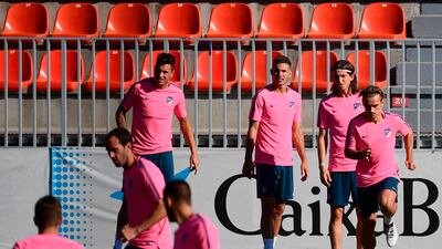 Atletico Madrid players take part in training ahead of the Uefa Champions League match against Chelsea. Pierre-Philippe Marcou / AFP