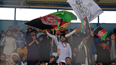 Spectators wave Afghanistan's and Taliban flags as they watch the Twenty20 cricket trial match being played between two Afghan teams, Peace Defenders and Peace Heroes, at the Kabul International Cricket Stadium. AFP