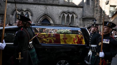 The hearse carrying the coffin of the queen travels slowly on the Royal Mile in Edinburgh. Reuters