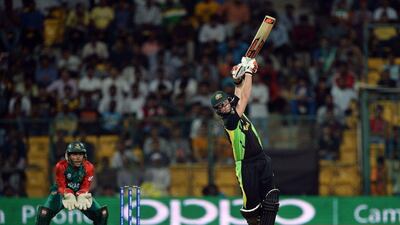 Australian batsman Steve Smith hits a six during the World T20 cricket tournament match between Australia and Bangladesh at The Chinnaswamy Stadium in Bangalore on March 21, 2016. / AFP / MANJUNATH KIRAN