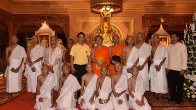 The rescued 11 Thai boys wear white robes pose with Buddhist monks at the Phra That Doi Wao Buddhist temple in the Mae Sai district of Chiang Rai province during the religious ordination ceremony on July 24, 2018. AFP