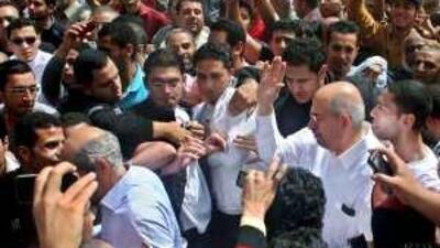 The former director of the IAEA Mohamed ElBaradei, waving on right, greets his supporters before Friday prayers. Mr ElBaradei is calling for Egypt to embrace democratic rule.