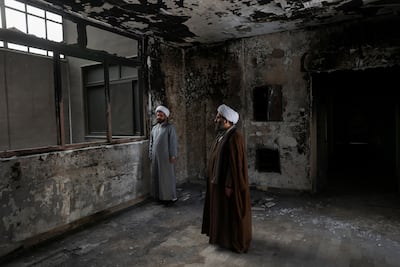 Iranian clerics visit the Islamic seminary in Tehran that was burnt during mass protests that spread across the country. Reuters