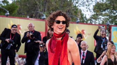 Timothee Chalamet, in a custom red backless outfit by custom blood red look by Haider Ackermann, attends the premiere of the film 'Bones and All' during the 79th edition of the Venice Film Festival on Friday, September 2, 2022. AP