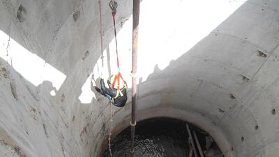 Police rescuers abseil down the well to reach the Frenchman. Courtesy Security Media.