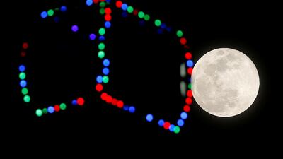 The moon rises next to a pod of a ferris wheel in downtown Malaga, southern Spain. Reuters