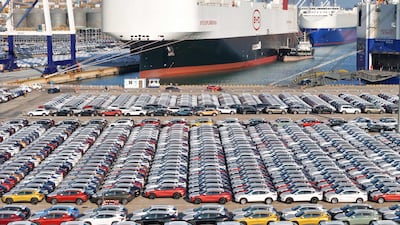 Electric cars at China's Yantai port. The Chinese economy is expected to lag behind the pace of economic growth of the broader Asian region. AFP
