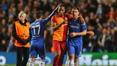 Didier Drogba shakes hands with Eden Hazard and Branislav Ivanovic following Tuesday's match. Clive Rose / Getty Images / March 18, 2014