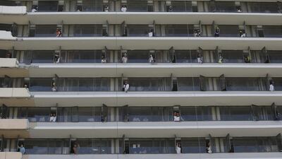 Filipino workers look from windows as a motorcade of Pacquiao passes by the financial district of Makati. Aaron Favila / AP Photo