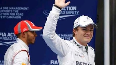 Nico Rosberg of Germany, right, acknowledges the cheers of the crowd in Shanghai after winning his first Formula One pole.
