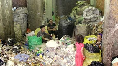 A Coptic Christian family selecting garbage to sell. Sandor Jaszberenyi / The National