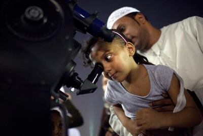 UAE residents look through a telescope to spot the Leonid meteor shower in 2021. The National