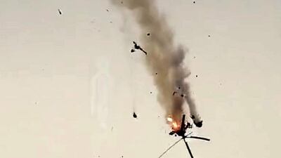 A Syrian government helicopter bursts in flames after it was hit by a missile in Idlib province on February 11, 2020. AFP