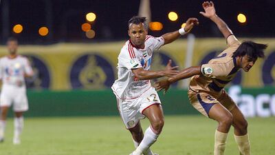 Dubai, United Arab Emirates- April, 27, 2013: (L) Luiz Fernando Silva of Al Jazira and (R) Ahmed Mallah of Dubai in action the Etisalat Pro-League match at the Dubai Sports & Cultural Club Stadium in Dubai. ( Satish Kumar / The National ) For Sports