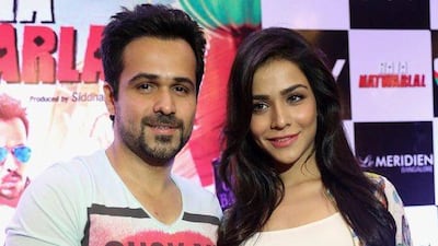 Indian Bollywood actor Emraan Hashmi, left, and Bollywod actress Humaima Malik, right, pose for photographs during the promotional event of their upcoming Hindi movie Raja Natwarlal in Bangalore, India, August 21 2014. EPA
