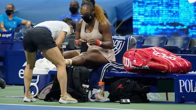 Serena Williams has her ankle taped by a trainer during a medical timeout during the US Open semi-final against Victoria Azarenka. AP