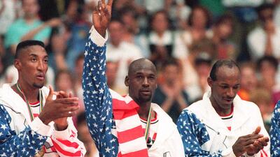 United States' Michael Jordan, centre, poses with his gold medal and a flag draped over his shoulder at the 1992 Olympics in Barcelona. (AP Photo/Susan Ragan, File)