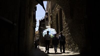 Tourists walk in an alley of Jerusalem’s Old City. Amir Cohen / Reuters / April 25, 2014
