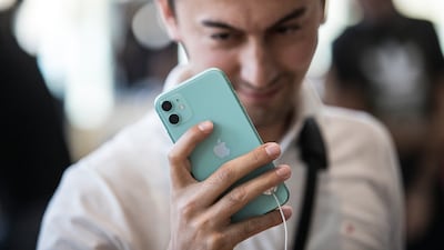 A customer looks at the iPhone 11 at an Apple store in Dubai Mall on September 20, 2019. EPA