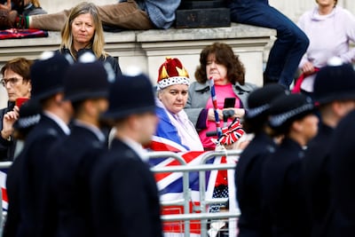 People watch a parade on the day of Britain's King Charles' coronation ceremony, in Whitehall, in London. Reuters