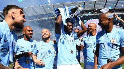 Yaya Toure lifts the Premier League trophy for the third time as a Manchester City player. Michael Regan / Getty Images