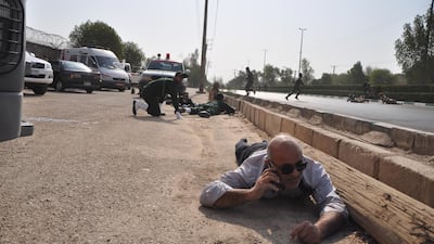 Iranian soldiers take cover during the terror attack at a military parade in the city of Ahvaz. EPA