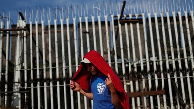 A migrant stands in front of the fortified border gate between Guatemala and Mexico, in Tecun Uman, Guatemala. Reuters
