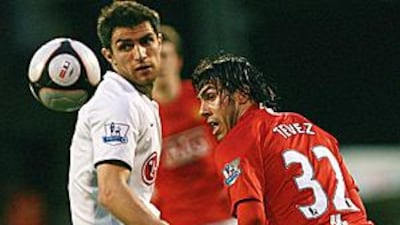 The movement and energy of Carlos Tevez, right, was too much to handle for Aaron Hughes, left, and Fulham.