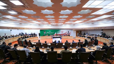 Iran's President Masoud Pezeshkian, centre back, during a press conference in Tehran. AFP