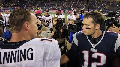 Peyton Manning, left, and Tom Brady are polar opposites in personality but have similar success on the field. Steven Senne / AP Photo