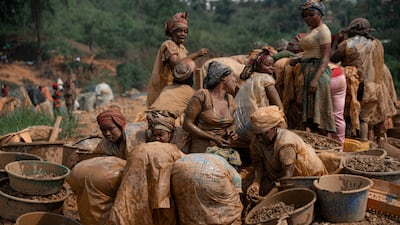 Women miners sort rocks containing gold particles in Mongbwalu, Ituri Province, Democratic Republic of the Congo. Health officials warn that population movement linked to artisanal mining is a factor in the spread of Ebola in the province. AFP