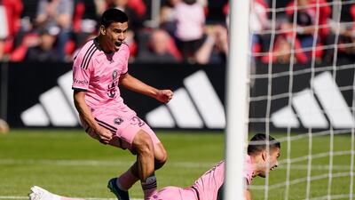 Luis Suarez and Diego Gomez react to a goal scored by Suarez during the first half. AP