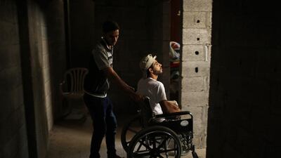 Mohammed Abed Al Dayem’s brother pushes him inside their house.