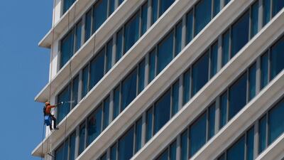 A worker cleans windows of a Shangri-La Hotels in Colombo. AFP