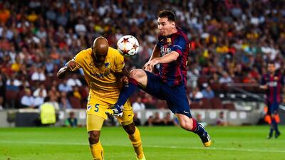 Barcelona's Lionel Messi competes for the ball with Carlao of Apoel Nicosia during Barca's 1-0 win in the Champions League on Wednesday night in Barcelona. David Ramos / Getty Images